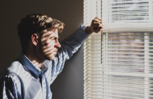 man going through divorce staring out window
