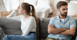 angry couple facing away from each other on couch