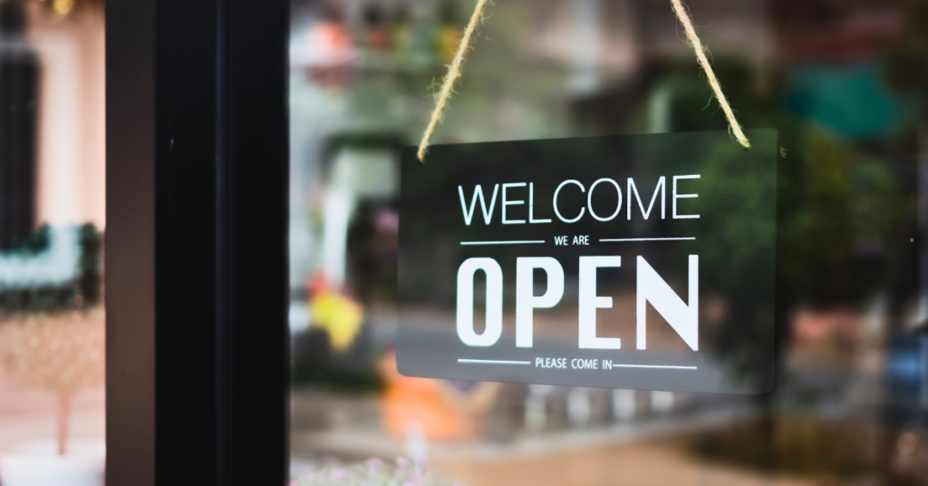 black and white welcome and open sign to a small business